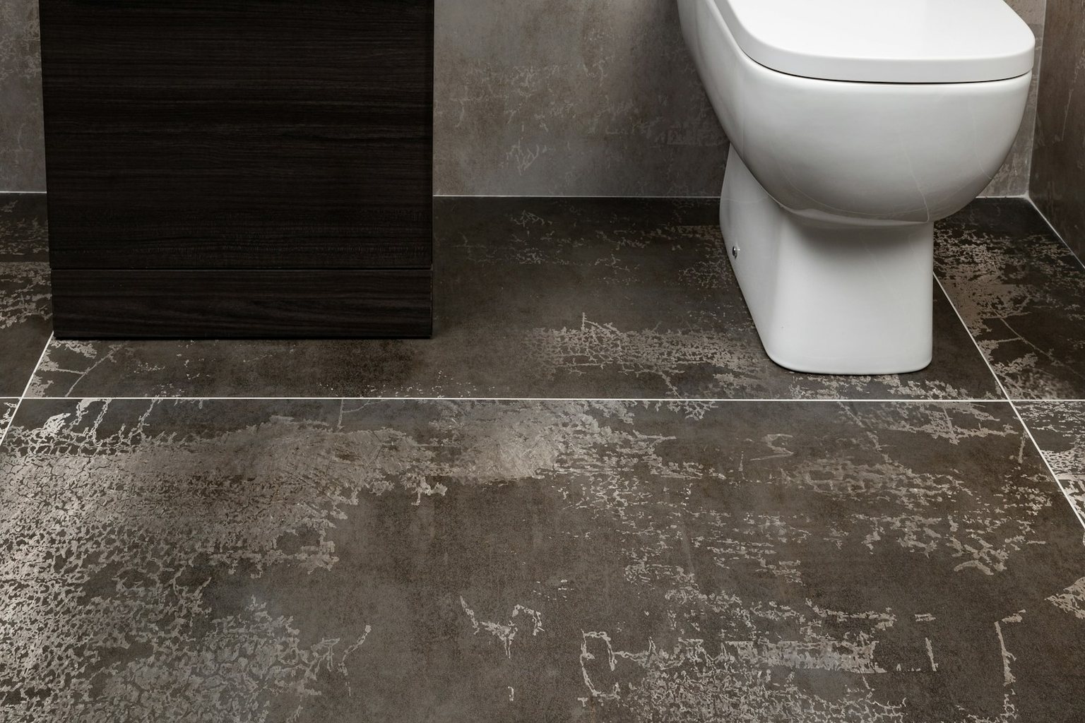 Bathroom with large dark patterned floor tiles