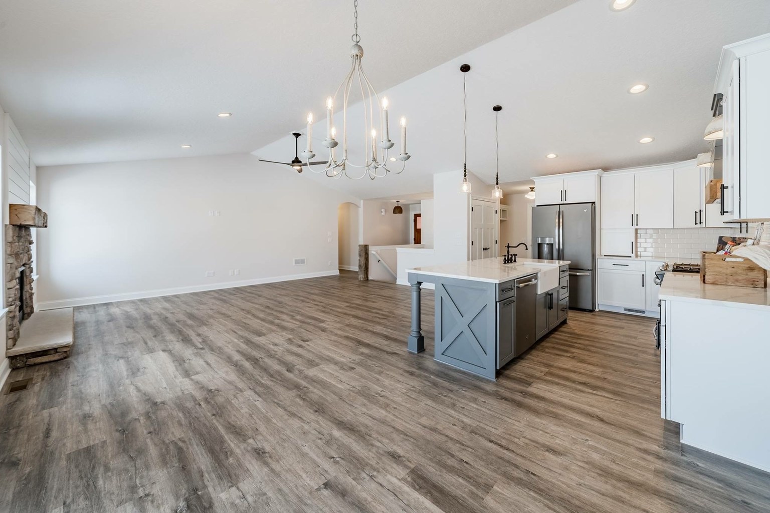 Wood-look luxury vinyl plank flooring across a bright open kitchen and living room.